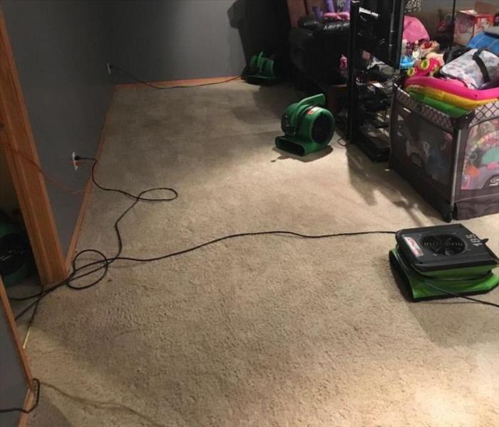 Air movers are set to dry carpet and drywall