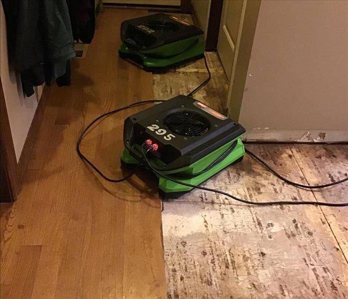 Warped flooring removed and air movers placed to dry