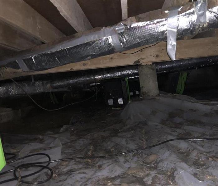 Crawlspace after the water has been pumped out and a vapor barrior has been installed.