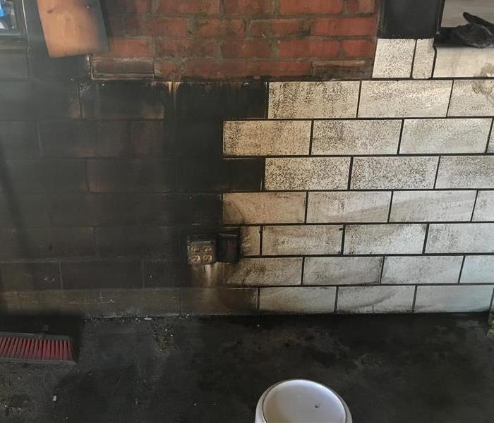 brick wall with left half black and right half white after cleaning